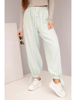 Dámské kalhoty se širokými nohavicemi a zavazováním dole tmavě mátové