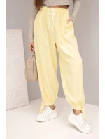 Dámské kalhoty s širokým nohavicím a zavazováním dole žluté
