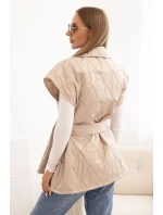 Dámská prošívaná vesta s páskem a širokým límcem tmavě béžová Dámská prošívaná vesta s páskem a širokým límcem tmavě béžová