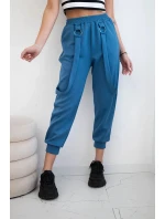 Kalhoty s ozdobnými proužky máslové látky džínovina