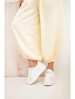 Dámské široké kalhoty s gumou v pase a zavazováním ve stylu aladinek žluté Dámské široké kalhoty s gumou v pase a zavazováním ve stylu aladinek žluté