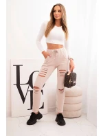 Dámské kalhoty z bavlny s roztržením a gumou v pase béžové